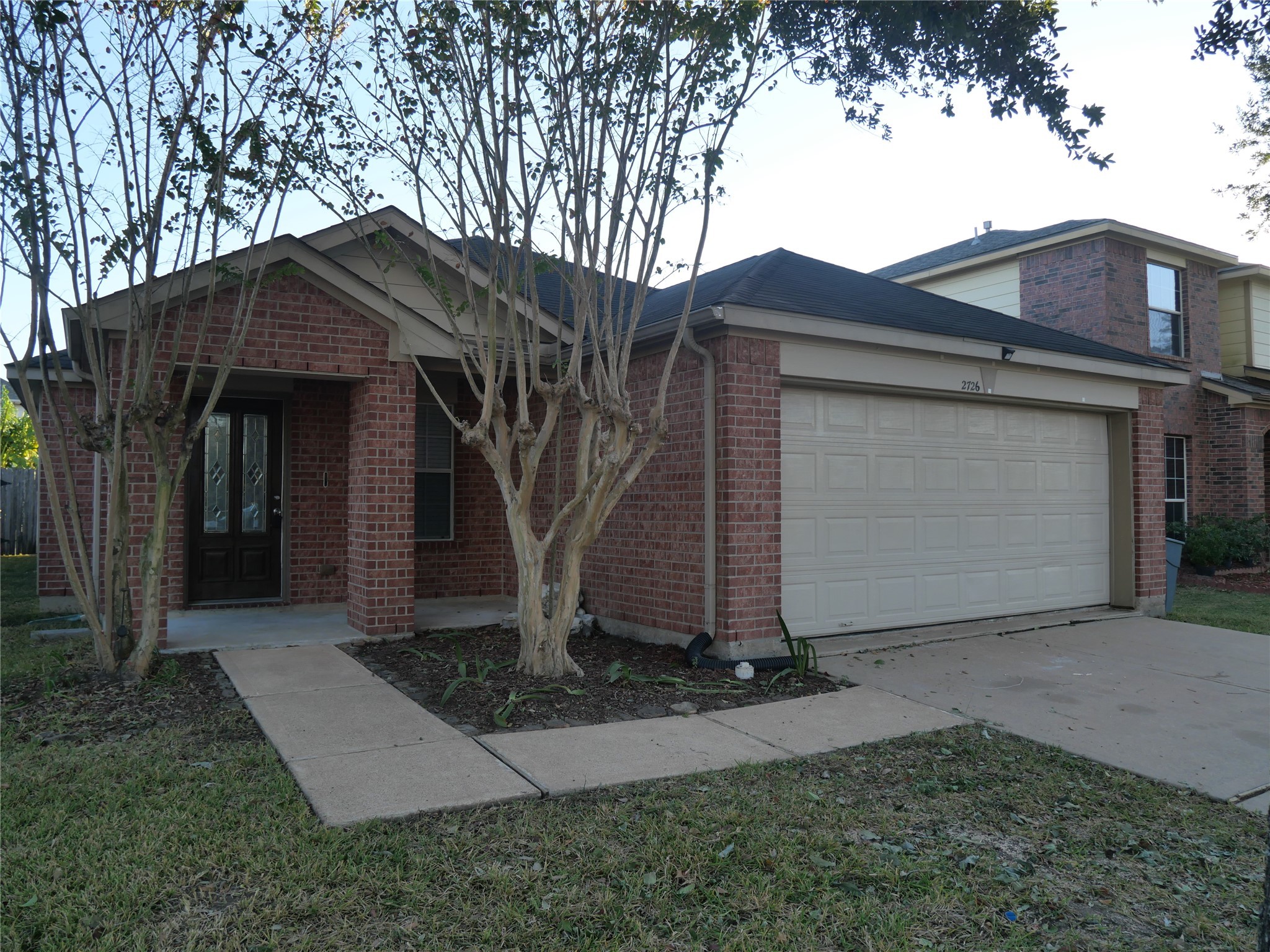 2726 Heatherwind Lane Houston, TX 77047 - Photo 1 of 27 a front view of a house with a yard and garage