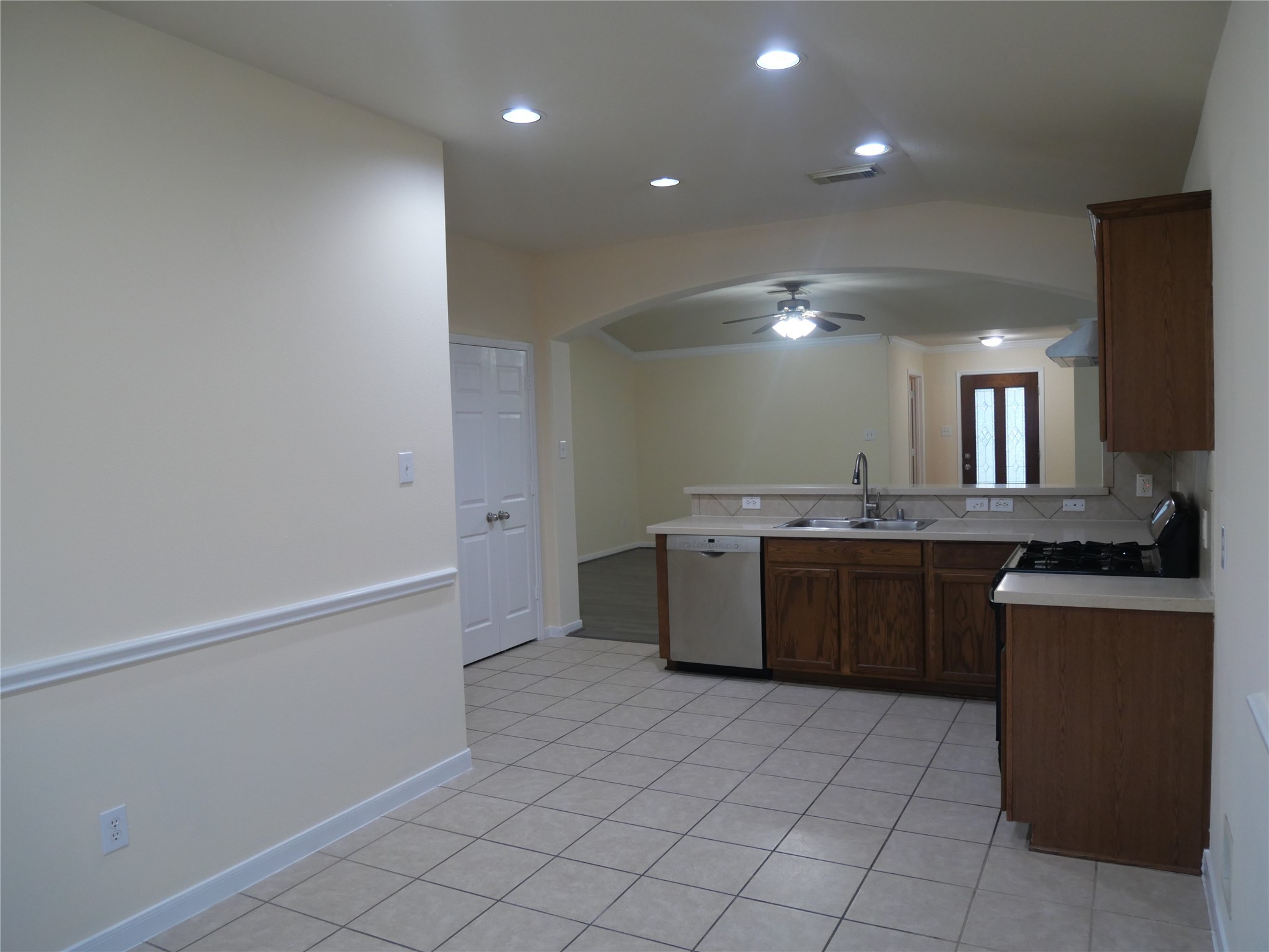 2726 Heatherwind Lane Houston, TX 77047 - Photo 13 of 27 a large kitchen with a sink and dishwasher a stove with wooden floor