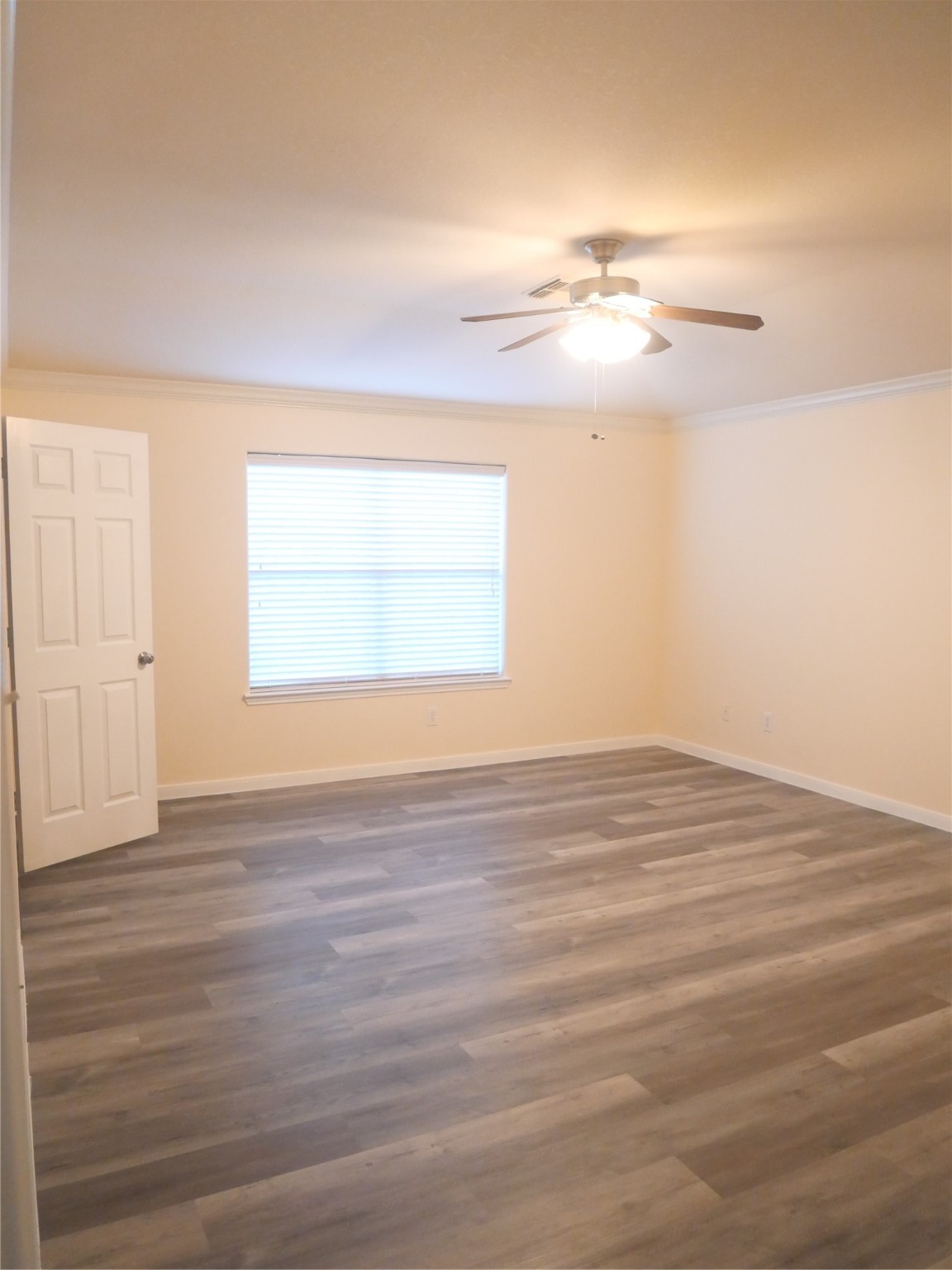 2726 Heatherwind Lane Houston, TX 77047 - Photo 16 of 27 an empty room with wooden floor and windows