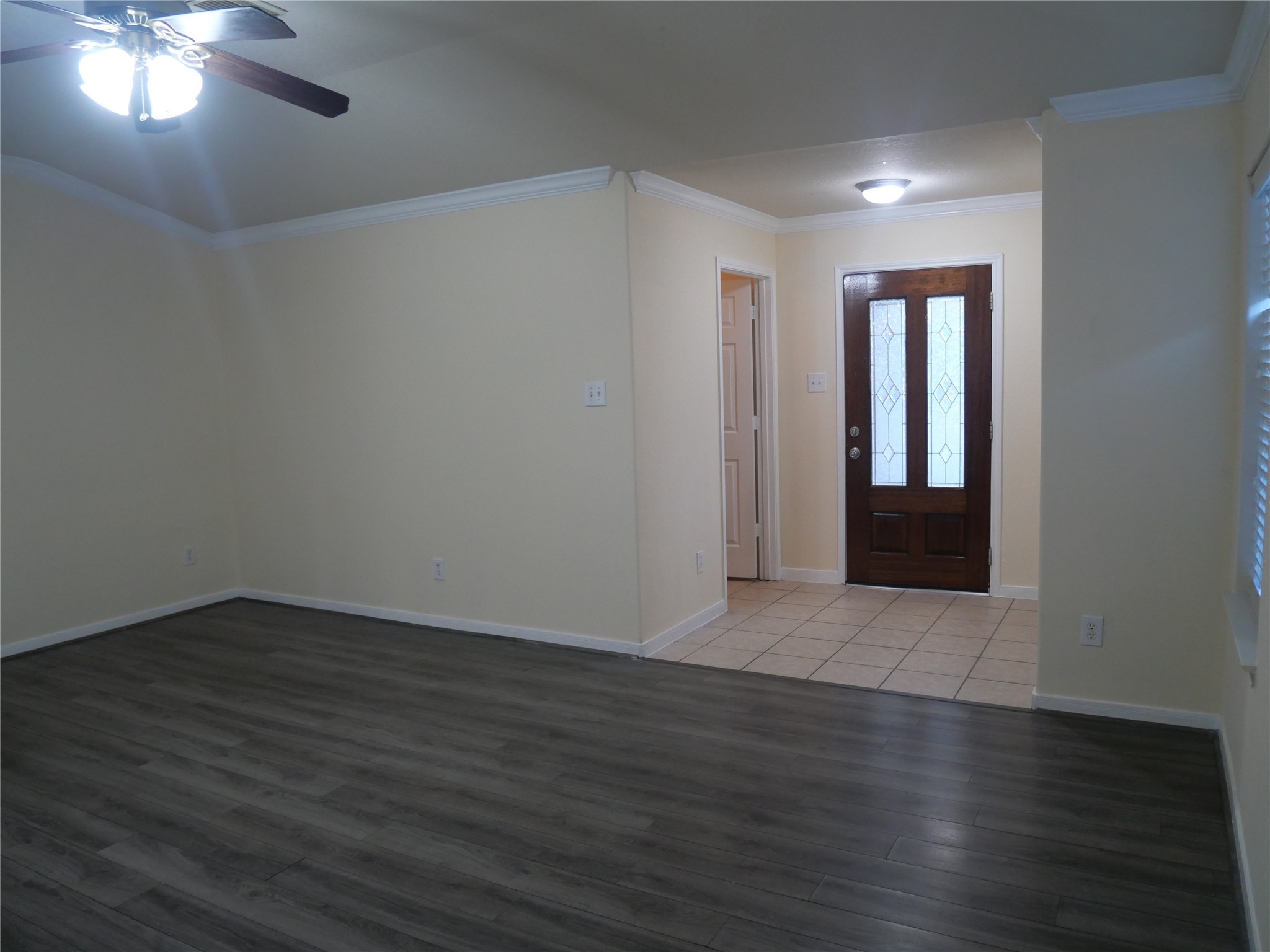 2726 Heatherwind Lane Houston, TX 77047 - Photo 4 of 27 a view of an empty room with wooden floor and a window