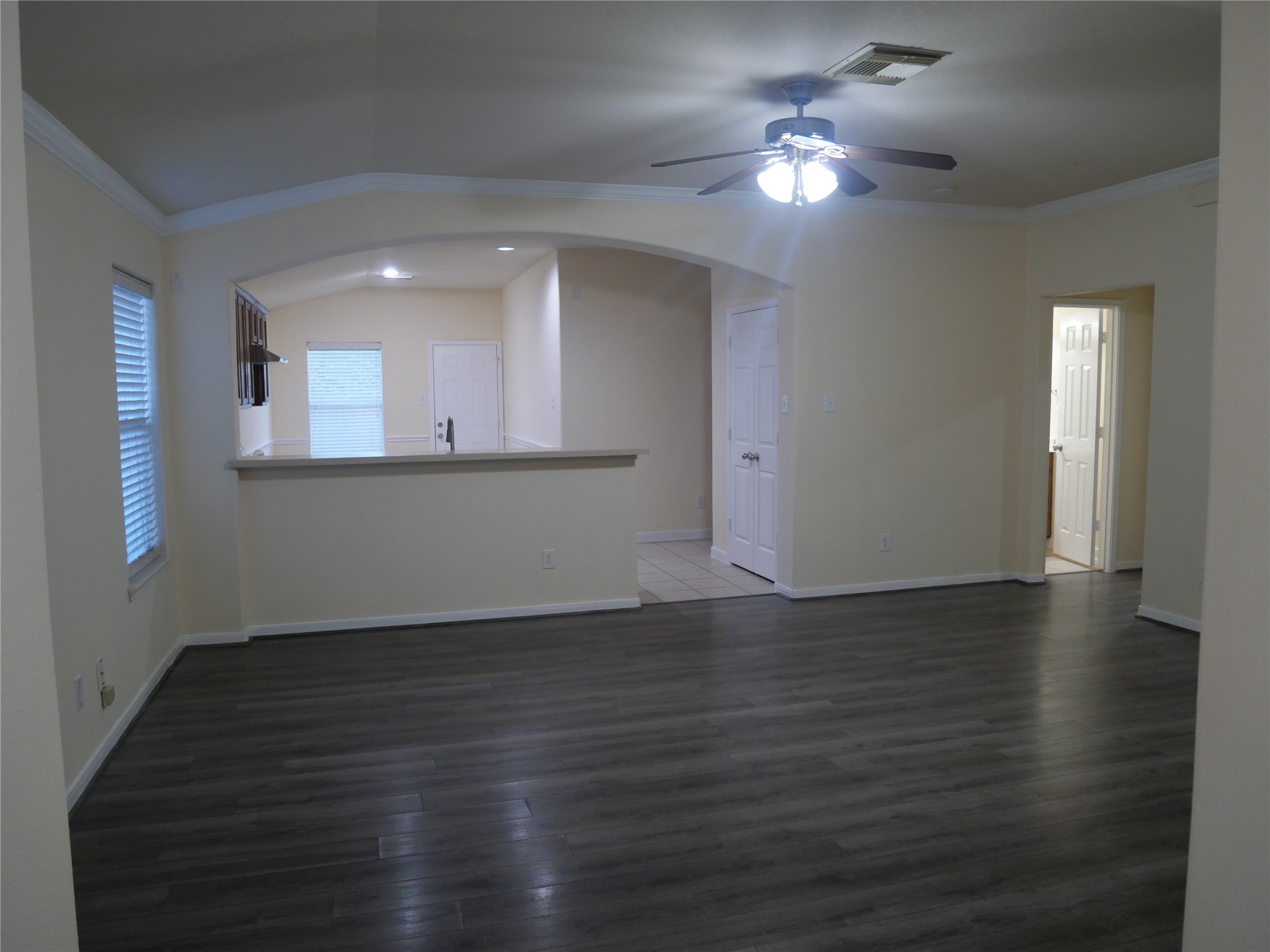 2726 Heatherwind Lane Houston, TX 77047 - Photo 5 of 27 a view of a kitchen with wooden floor and a chandelier fan