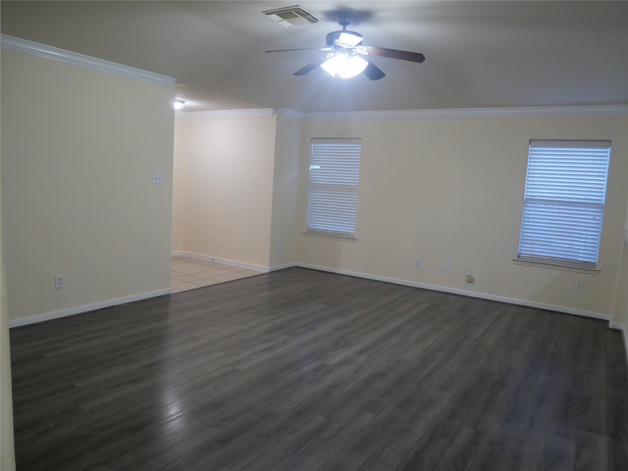 2726 Heatherwind Lane Houston, TX 77047 - Photo 7 of 27 an empty room with wooden floor and windows