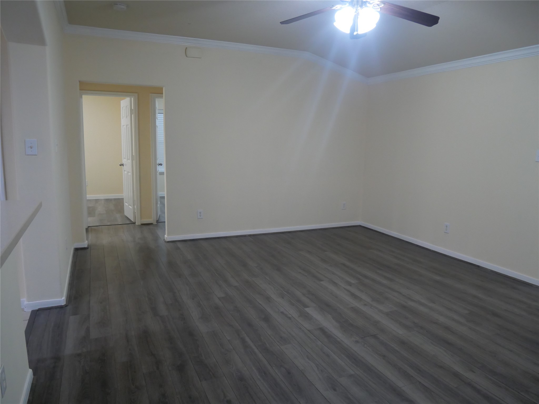 2726 Heatherwind Lane Houston, TX 77047 - Photo 8 of 27 a view of a room with wooden floor and a ceiling fan