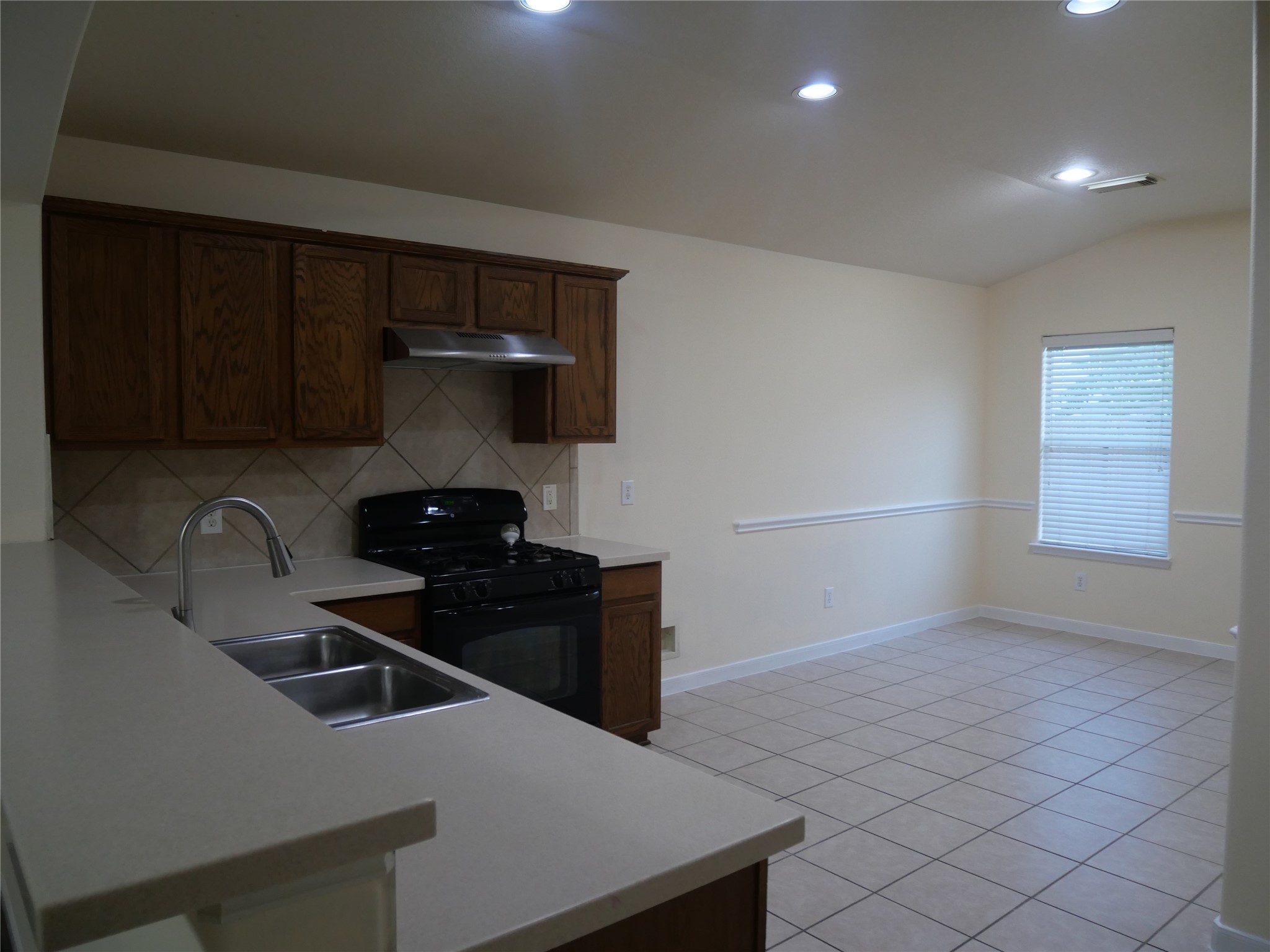 2726 Heatherwind Lane Houston, TX 77047 - Photo 10 of 27 a kitchen with a sink and a stove top oven