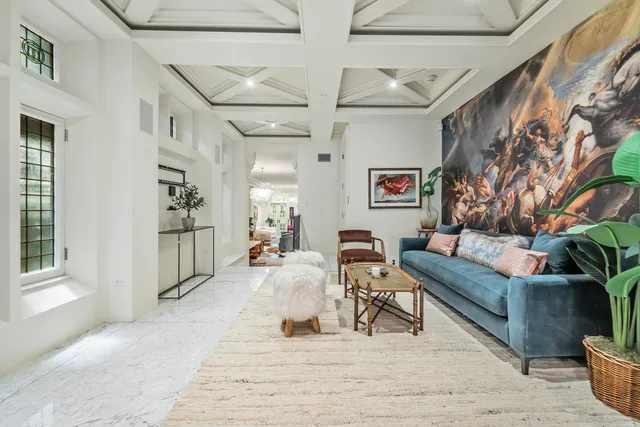 a kitchen with a dining table chairs and a chandelier