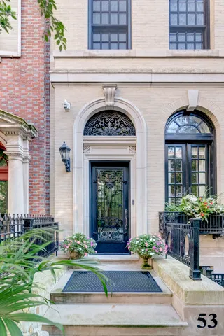 a living room with furniture a chandelier and a dining table