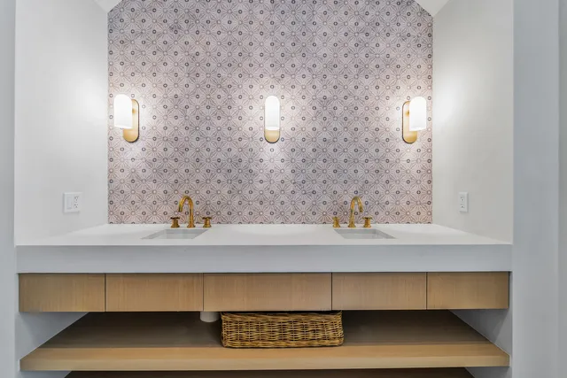 a bedroom with a bed and a dresser next to a window