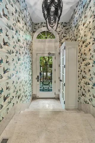 a living room with fireplace furniture and a potted plant