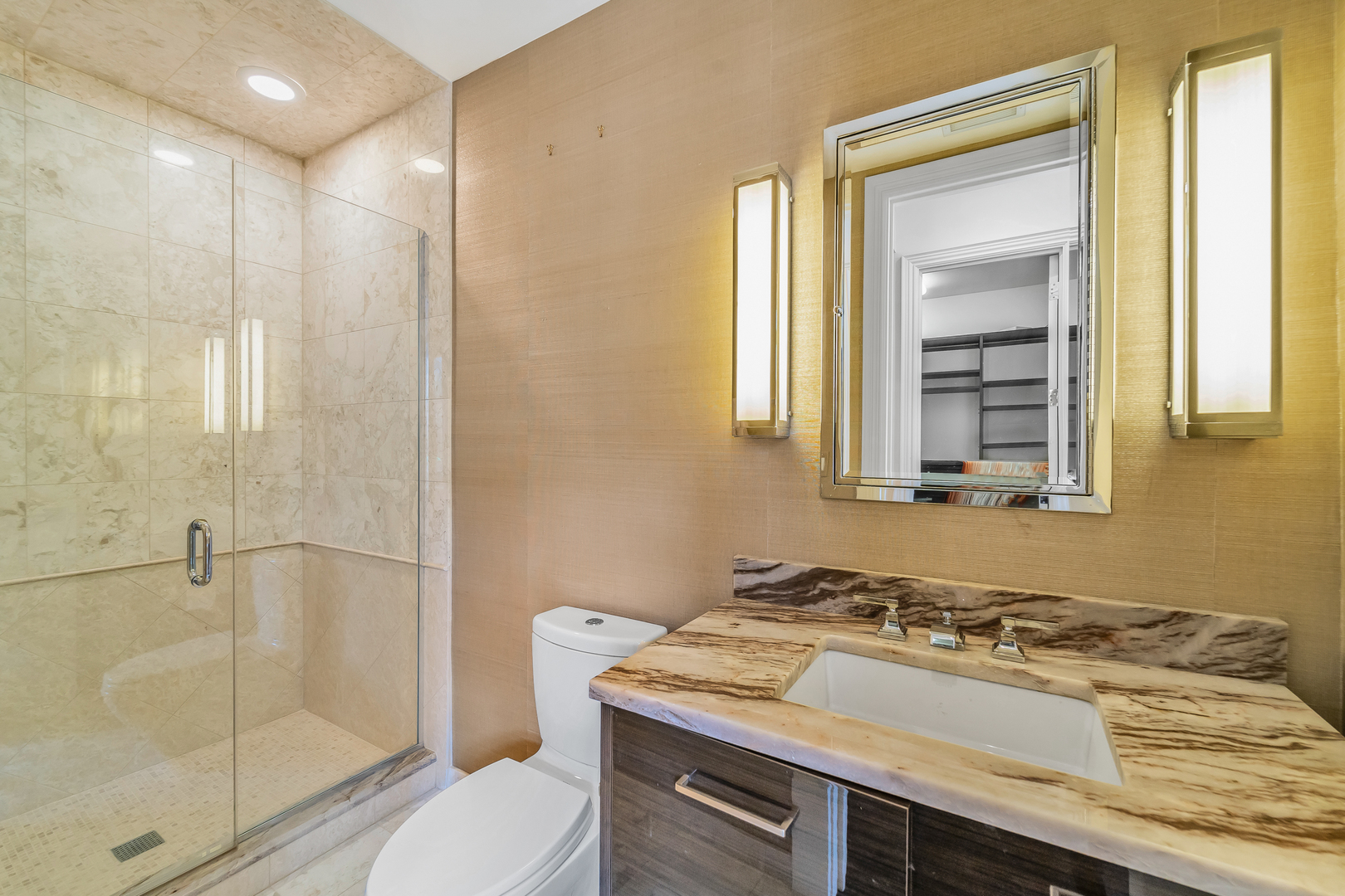 53 East Division Street Chicago, IL 60611 - Photo 43 of 79 a bathroom with a granite countertop sink toilet and shower