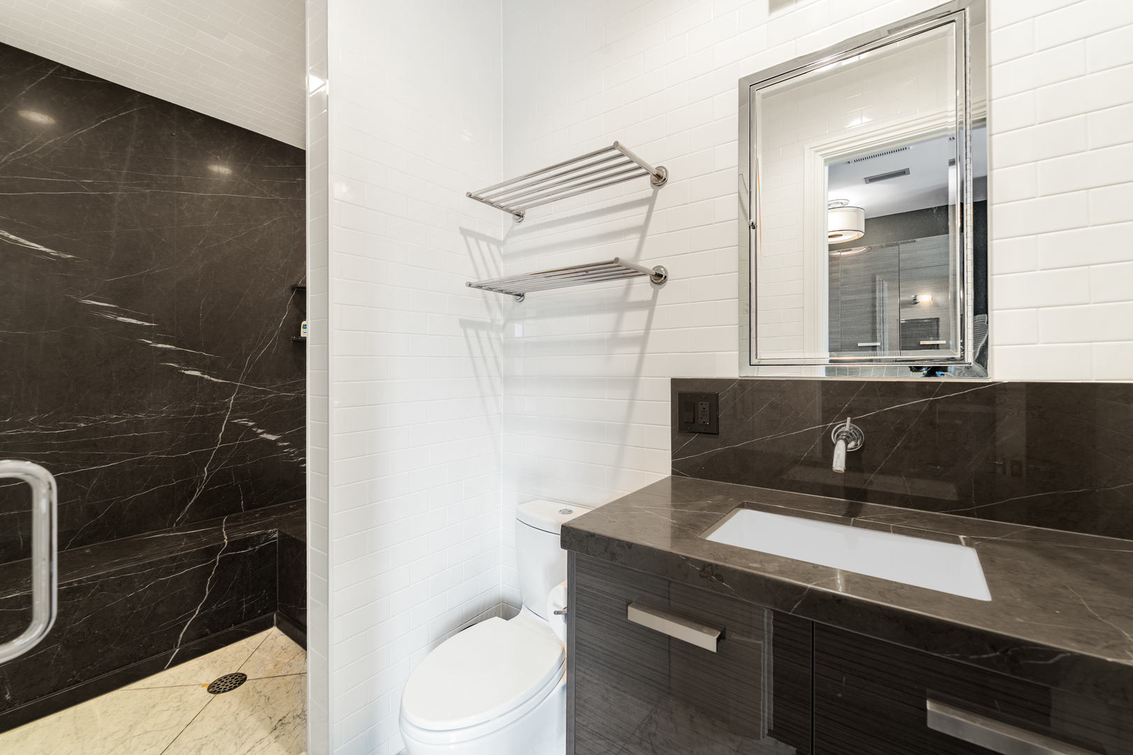 53 East Division Street Chicago, IL 60611 - Photo 49 of 79 a bathroom with a sink a toilet and shower