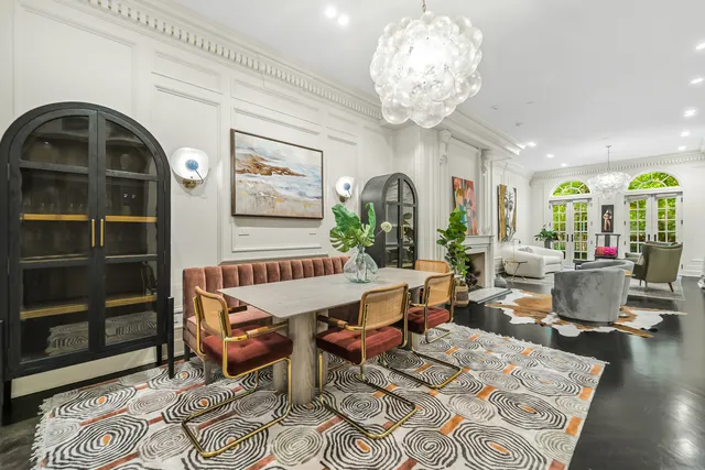 a living room with furniture a fireplace and wall paintings