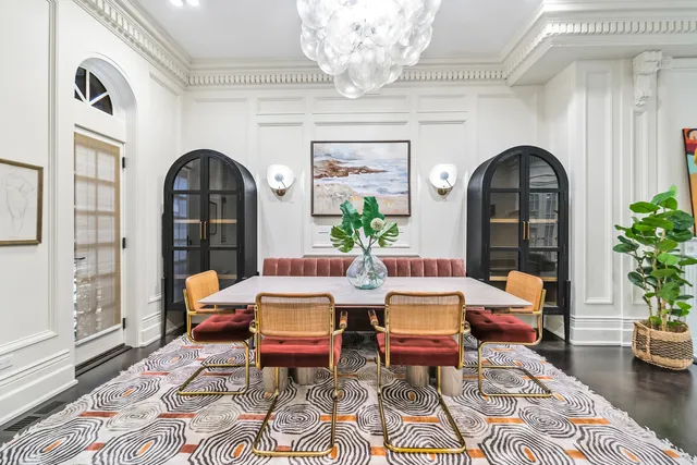 a living room with furniture and a chandelier
