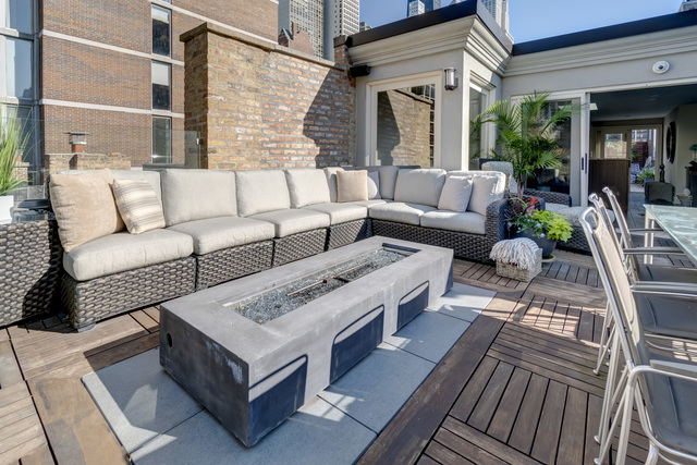 53 East Division Street Chicago, IL 60611 - Photo 71 of 79 a view of a patio with couches and a potted plant on a table