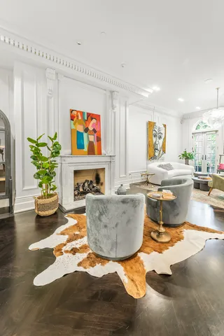 a living room with fireplace furniture and a chandelier