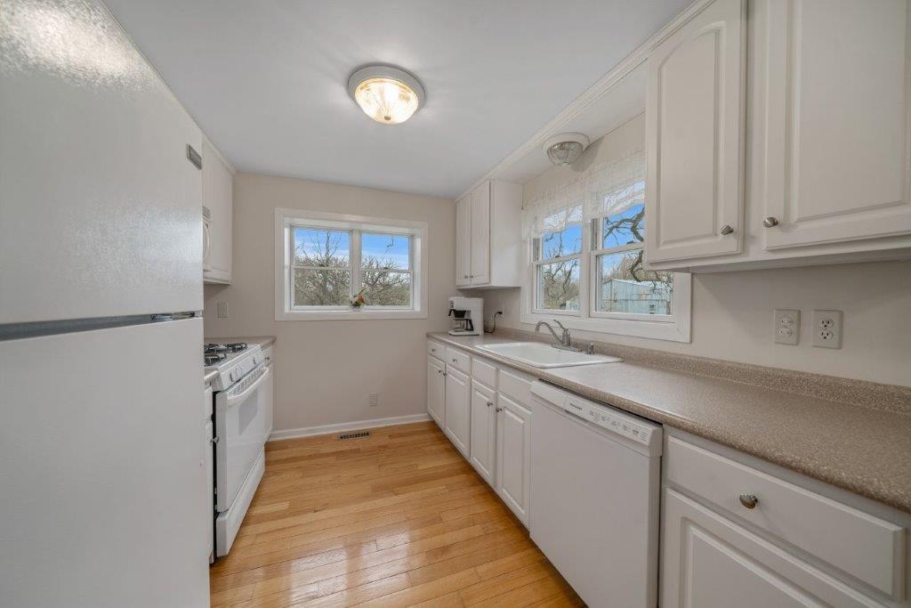 8709 Elevator Road Roscoe, IL 61073 - Photo 11 of 25 a kitchen with a sink a refrigerator and window