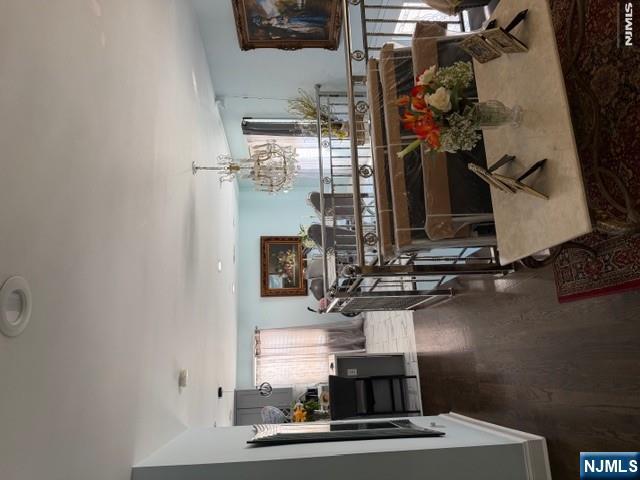 177 Maple Street Fairview, NJ 07022 - Photo 2 of 24 a kitchen with a sink dishwasher a dining table and chairs with wooden floor