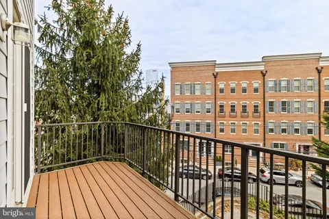 a view of balcony with wooden floor and fence