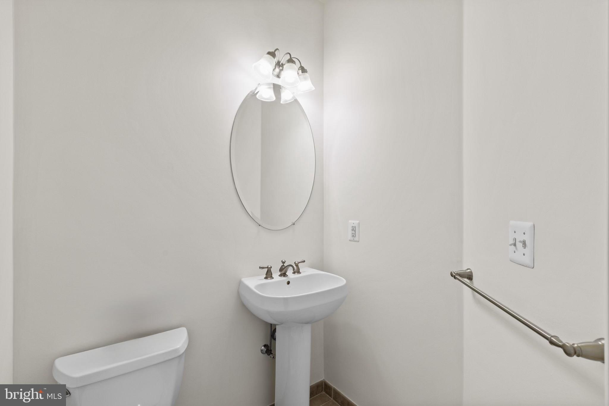 508 Governors Court Philadelphia, PA 19146 - Photo 14 of 54 a bathroom with a sink a mirror and a toilet