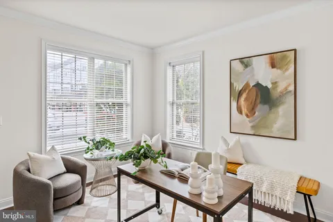 a living room with furniture chandelier and a window