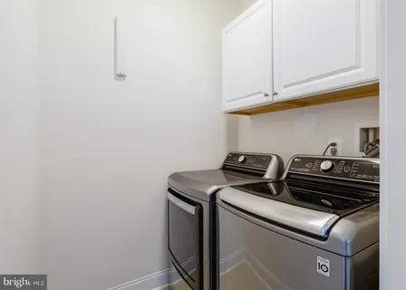 a front view of a building with lot of cars and trees