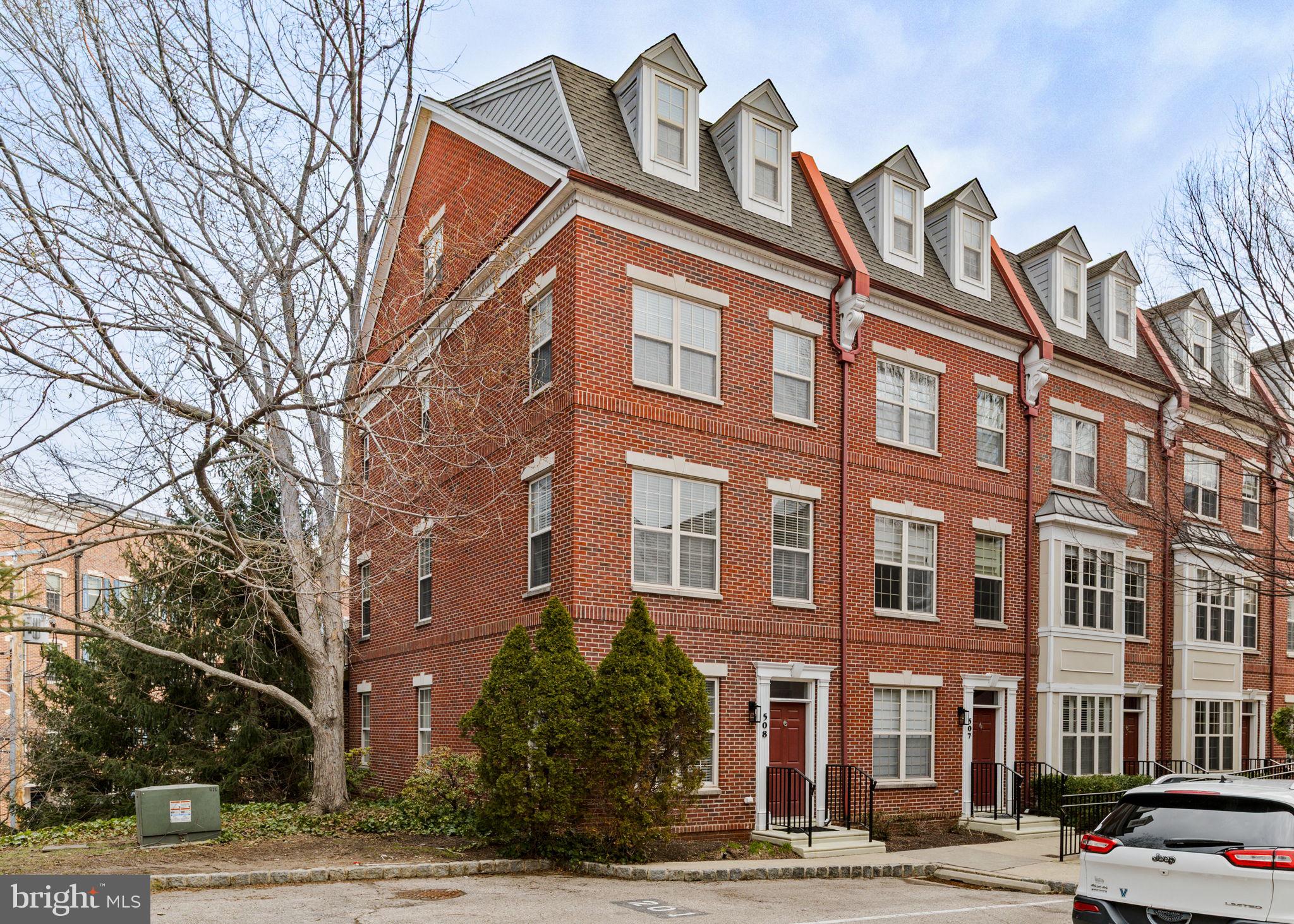 508 Governors Court Philadelphia, PA 19146 - Photo 33 of 54 a front view of a building with lot of cars and trees