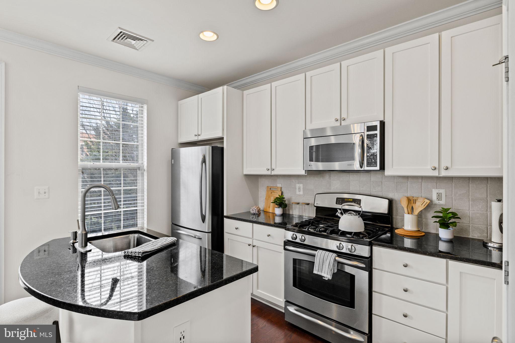508 Governors Court Philadelphia, PA 19146 - Photo 10 of 54 a kitchen with stainless steel appliances granite countertop a sink a stove and a refrigerator