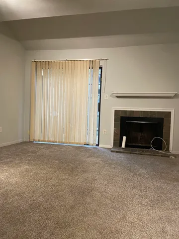 an empty room with furniture and a fireplace