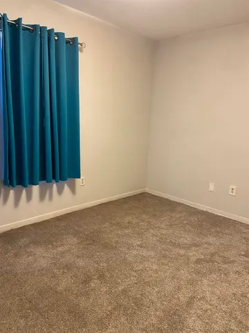 a view of a room with wooden fence