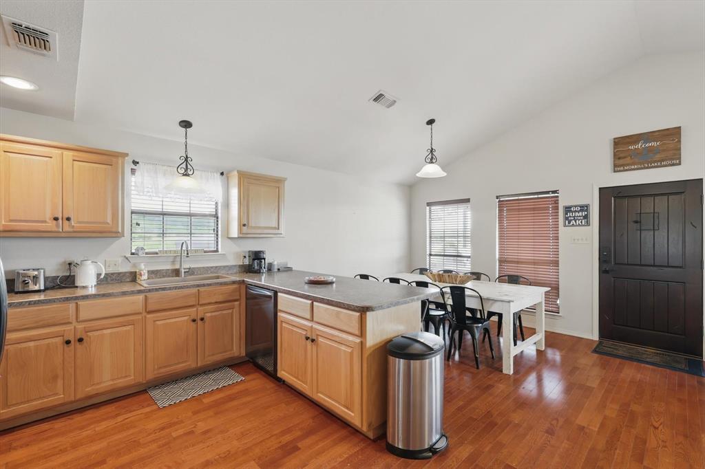 186 West Hells Gate Drive Strawn, TX 76475 - Photo 11 of 40 a kitchen with lots of counter top space and dining table