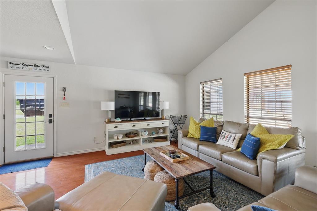 186 West Hells Gate Drive Strawn, TX 76475 - Photo 14 of 40 a living room with furniture flat screen tv and wooden floor