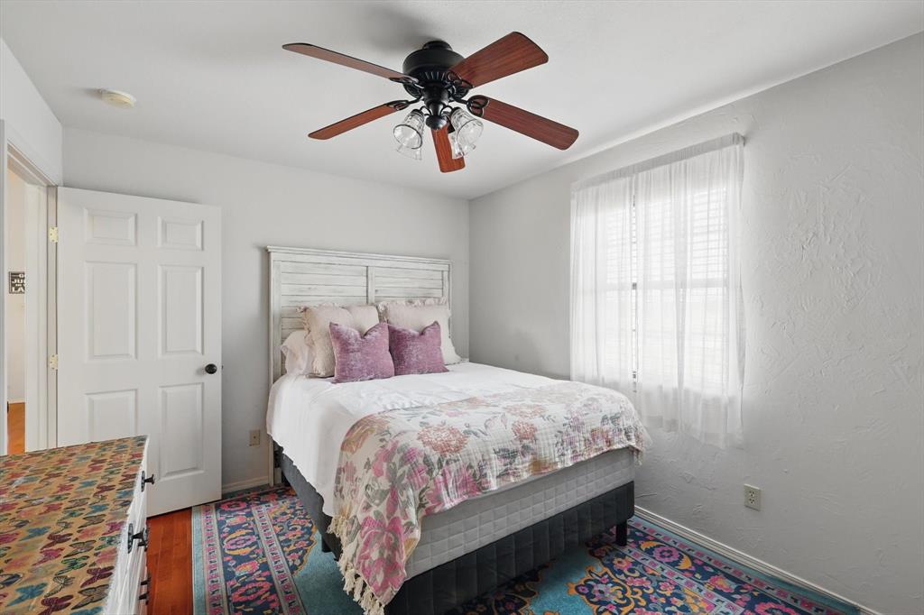 186 West Hells Gate Drive Strawn, TX 76475 - Photo 17 of 40 a bedroom with a bed and a chandelier