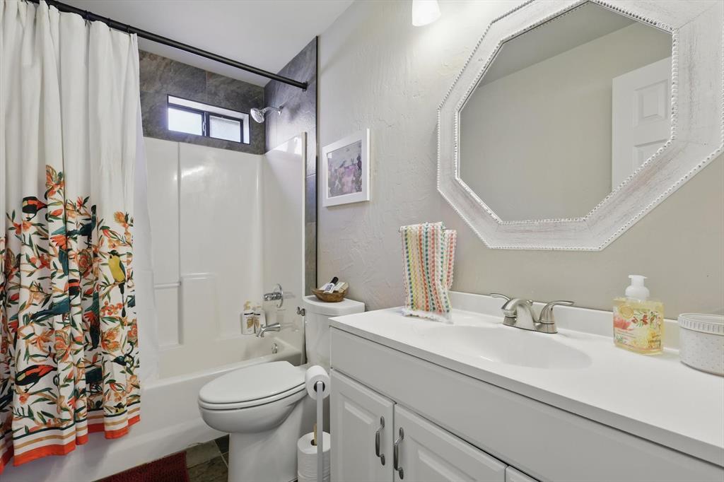 186 West Hells Gate Drive Strawn, TX 76475 - Photo 20 of 40 a bathroom with a sink a toilet and shower