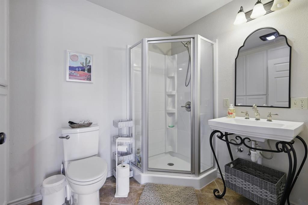 186 West Hells Gate Drive Strawn, TX 76475 - Photo 22 of 40 a bathroom with a sink a toilet and shower