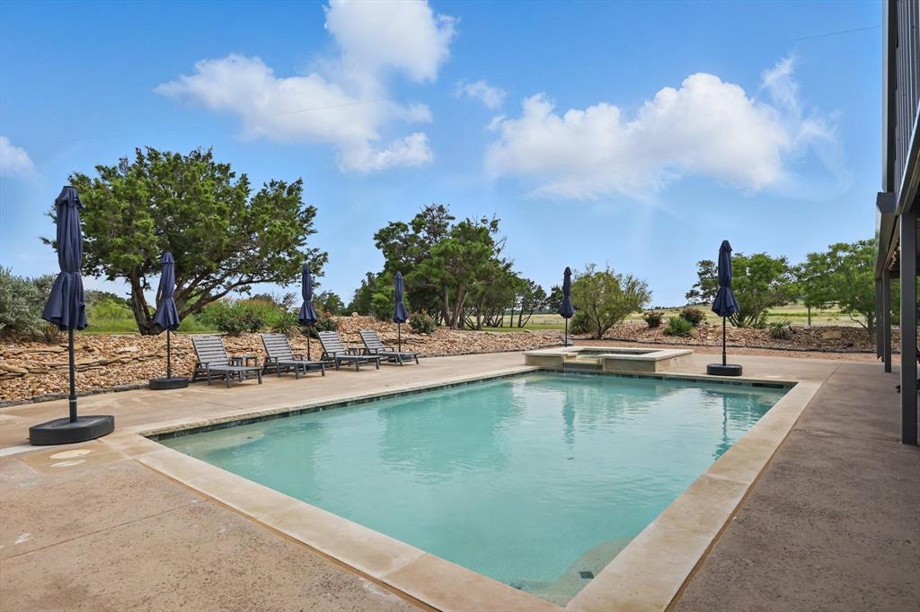 186 West Hells Gate Drive Strawn, TX 76475 - Photo 24 of 40 a view of a swimming pool with a lawn chairs