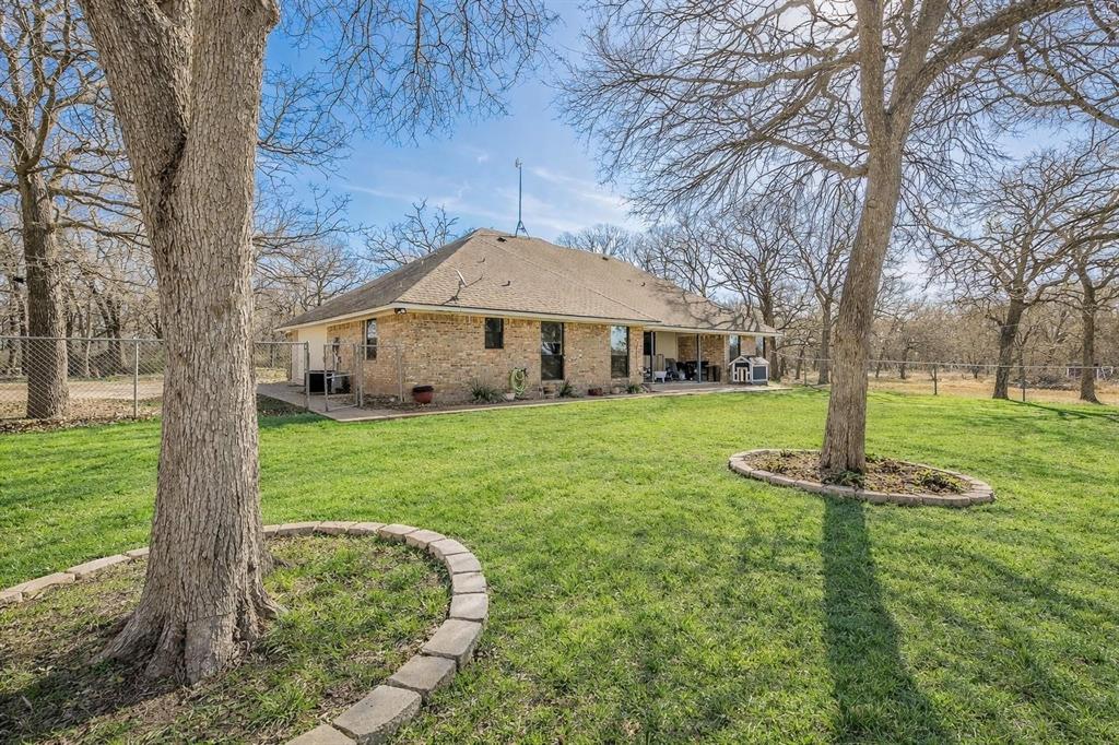 1325 North Katy Road Elm Mott, TX 76640 - Photo 28 of 30 a front view of a house with garden