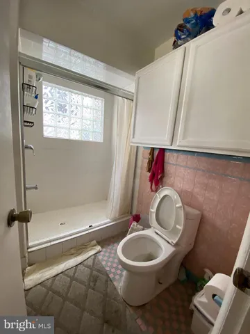a bathroom with a toilet a sink and a mirror