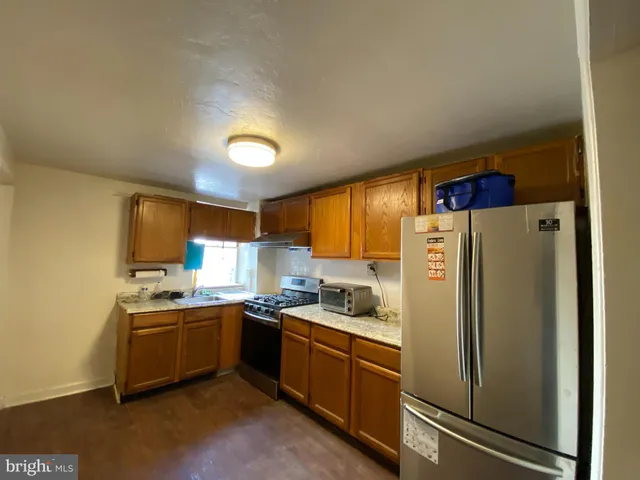 a kitchen with stainless steel appliances a refrigerator sink and cabinets