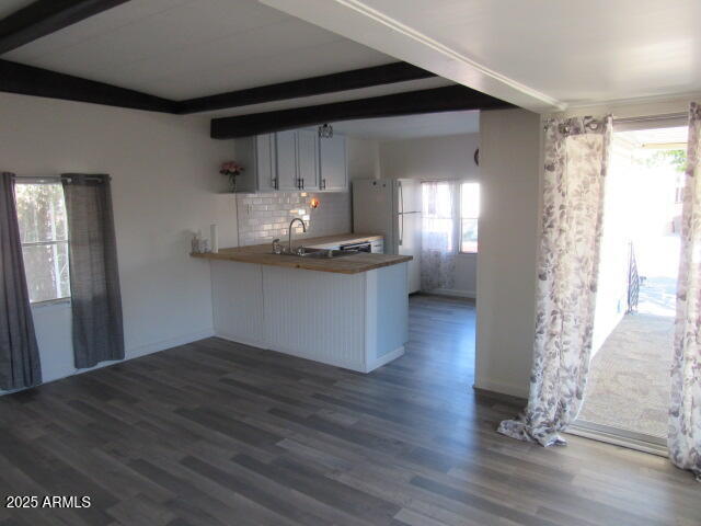 3411 South Camino Seco, Unit 401 Tucson, AZ 85730 - Photo 3 of 17 a kitchen with granite countertop a stove and a wooden floor