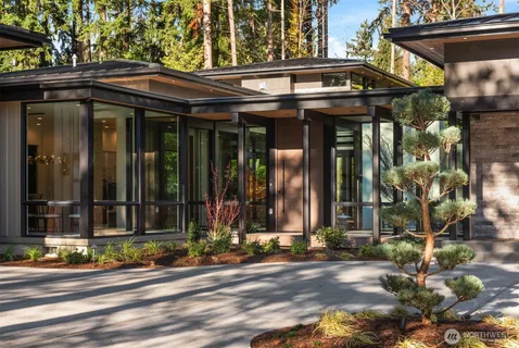 a living room with furniture large window and a fireplace