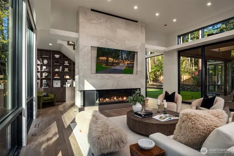 a living room with furniture potted plant and a large window