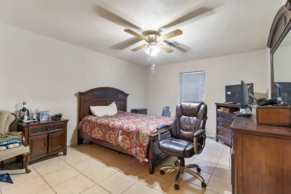 a bathroom with a granite countertop sink a mirror and shower