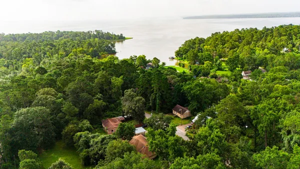 a aerial view of a house with a yard