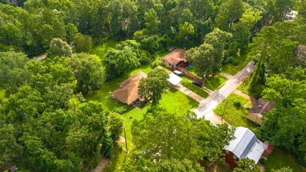 an aerial view of a house with a yard