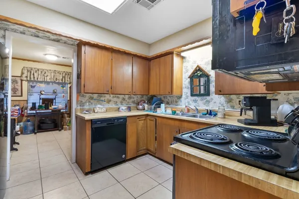 a kitchen that has a sink and a stove in it