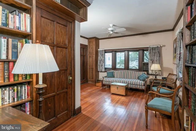 a view of a livingroom with furniture hardwood floor and a book shelf