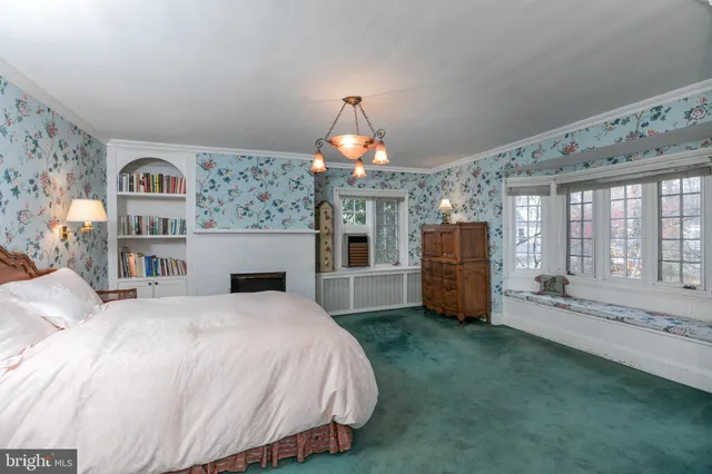 a spacious bedroom with a bed mirror and window