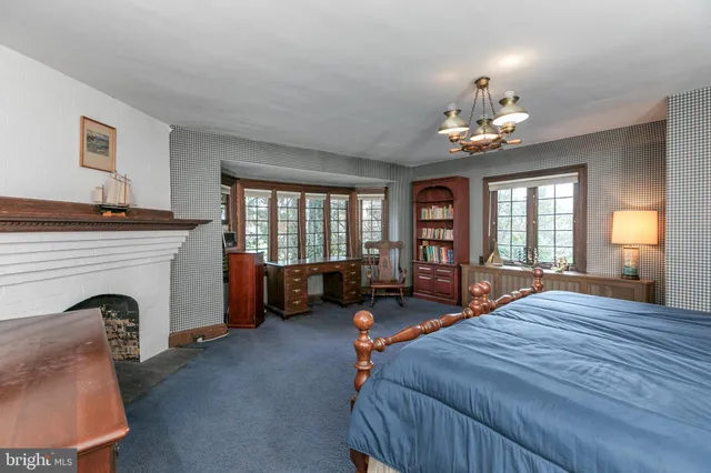 a bedroom with furniture and a fireplace