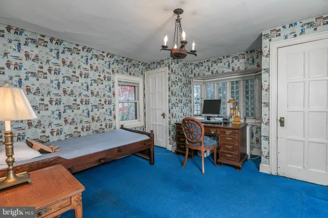 a bedroom with furniture and a chandelier