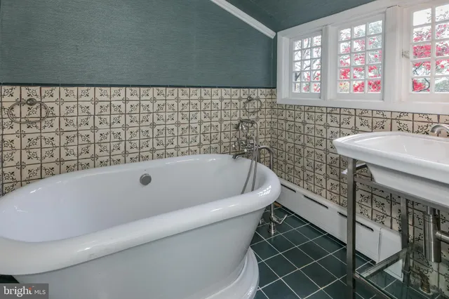 a bathroom with a bathtub and a sink