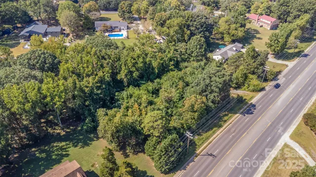 an aerial view of residential houses with yard